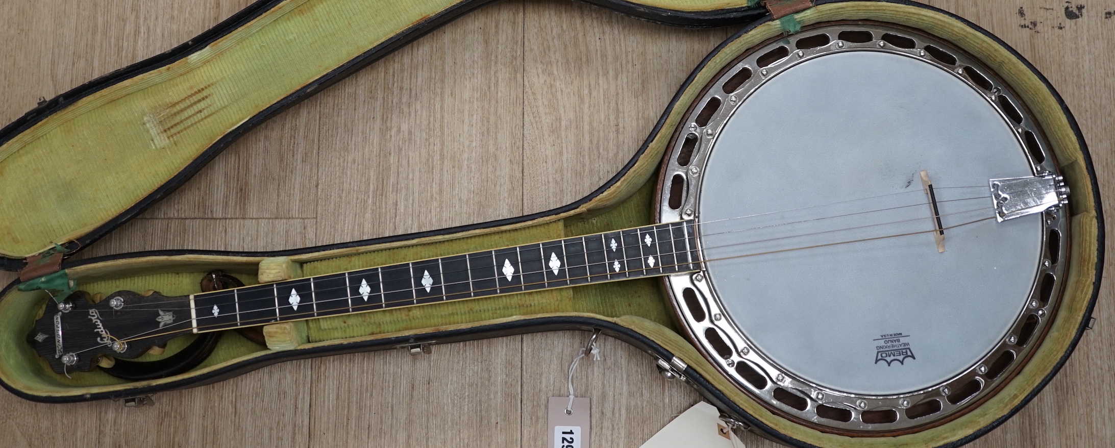 A cased 1920s Ludwig 'Kingston', USA tenor four string banjo, inlaid back, mother of pearl inlay to the fretboard, modern Remo skin, length of body 34cm, overall length 87cm, in a fitted hard case